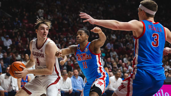 Jan 14, 2025; Tuscaloosa, Alabama, USA; Alabama Crimson Tide forward Grant Nelson (4) works against Mississippi Rebels guard Matthew Murrell (11) and guard Sean Pedulla (3) during the first half at Coleman Coliseum. Jan 14, 2025; Tuscaloosa, Alabama, USA; Alabama Crimson Tide forward Grant Nelson (4) works against Mississippi Rebels guard Matthew Murrell (11) and guard Sean Pedulla (3) during the first half at Coleman Coliseum.