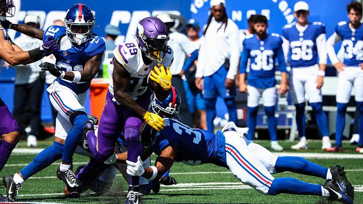 Aug 15, 2026; East Rutherford, New Jersey, USA;  Minnesota Vikings wide receiver Dillon Bell (89) fights for yards as New York Giants safety Beau Brade (34) tackles during the second half at MetLife Stadium. Mandatory Credit: Vincent Carchietta-Imagn Images