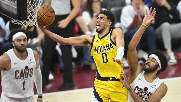 May 6, 2025; Cleveland, Ohio, USA; Indiana Pacers guard Tyrese Haliburton (0) drives to the basket between guard Max Strus (1) and center Jarrett Allen (31) in the fourth quarter during game two of the second round of the 2025 NBA Playoffs at Rocket Arena. Mandatory Credit: David Richard-Imagn Images