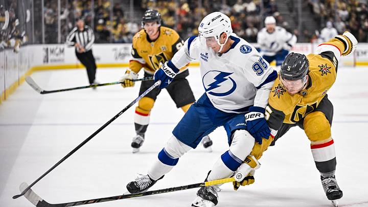 Ilya Mikheyev and Jeremy Lauzon battle for the puck as Mitch Marner looks on Ilya Mikheyev and Jeremy Lauzon battle for the puck as Mitch Marner looks on
