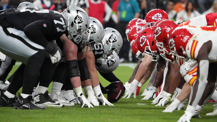 Nov 26, 2023; Paradise, Nevada, USA; Helmets at the line of scrimmage as Las Vegas Raiders long snapper Jacob Bobenmoyer (50) snaps the ball against the Kansas City Chiefs in the second half at Allegiant Stadium. Mandatory Credit: Kirby Lee-Imagn Images