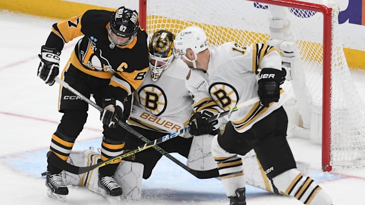 Apr 13, 2024; Pittsburgh, Pennsylvania, USA;  Pittsburgh Penguins center Sidney Crosby (87) pressures Boston Bruins goalie Linus Ullmark (35) near defenseman Kevin Shattenkirk (12) at PPG Paints Arena. Mandatory Credit: Philip G. Pavely-Imagn Images