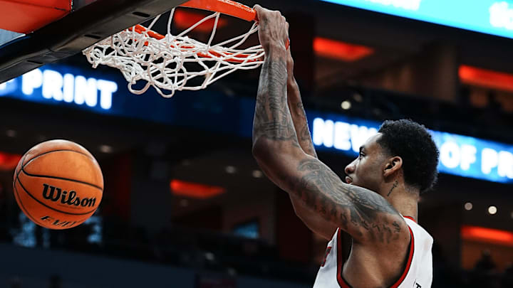 Louisville's James Scott (0) dunks against Ole Miss during their game at the KFC Yum! Center in Louisville, Ky. on Dec. 3, 2024.