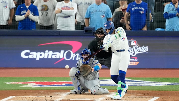 Oct 24, 2025; Toronto, Ontario, CAN; Toronto Blue Jays second baseman Bo Bichette (11) hits a single against the Los Angeles Dodgers in the first inning during game one of the 2025 MLB World Series at Rogers Centre. Mandatory Credit: Kevin Sousa-Imagn Images