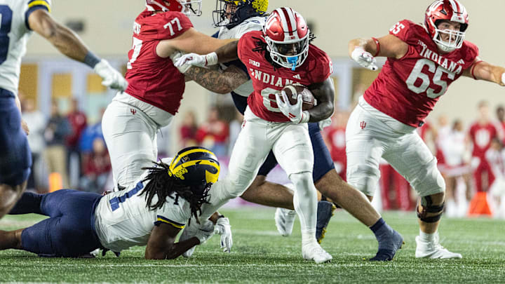 Indiana Hoosiers running back Kaelon Black (8) runs with the ball while Michigan Wolverines linebacker Jaishawn Barham (1) defends in the second half at Memorial Stadium.