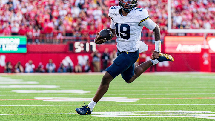 Sep 20, 2025; Lincoln, Nebraska, USA; Michigan Wolverines quarterback Bryce Underwood (19) runs against the Nebraska Cornhuskers during the fourth quarter at Memorial Stadium. Mandatory Credit: Dylan Widger-Imagn Images