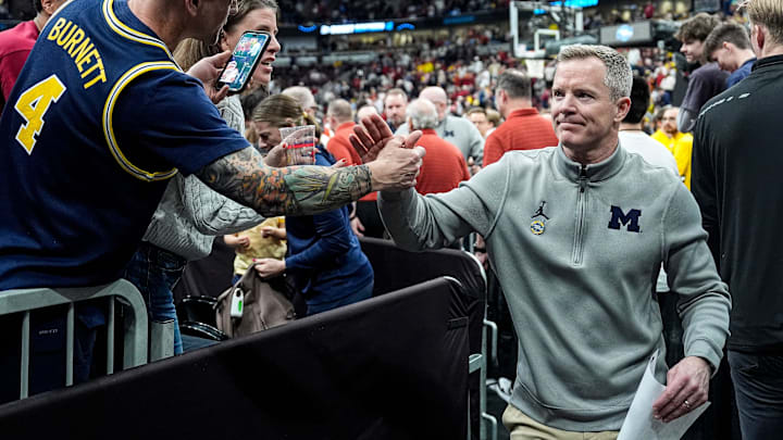 Michigan head coach Dusty May shakes hands with fans to celebrate a 90-77 win over Alabama at the NCAA Tournament Sweet 16 round at the United Center in Chicago on Friday, March 27, 2026.