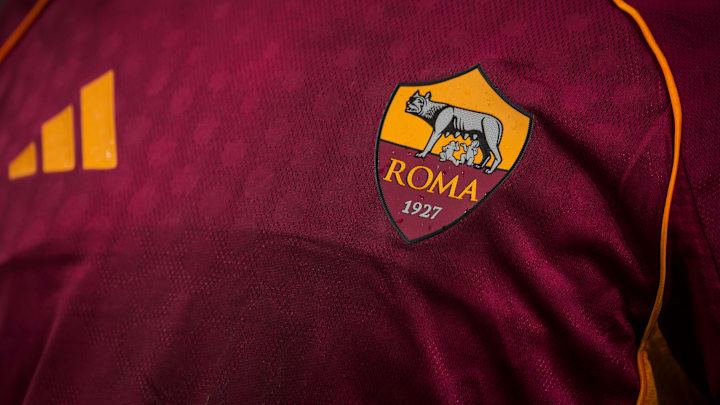 The logo of AS Roma is seen on the jersey worn by Paulo
