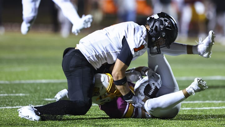 Ryle Raiders' Landon Lorms (1) fights for the ball during the second half of the high school football game between neighborhood rivals Cooper Jaguars and Ryle Raiders on Friday, Sept. 6, 2024, at Cooper High School. Cooper won 21-14.