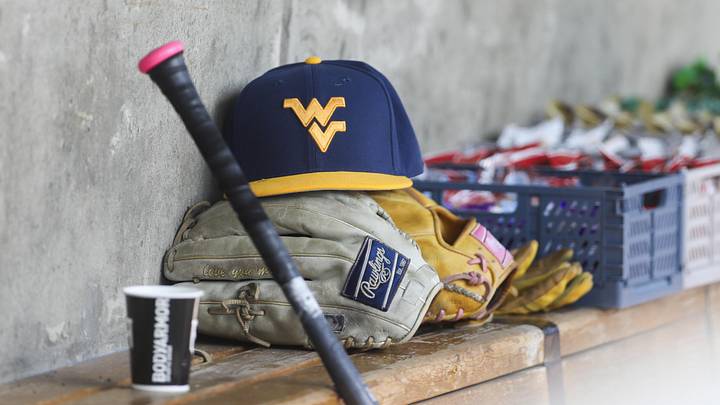 Jun 5, 2026; Morgantown, WV, USA; A West Virginia Mountaineers hat and glove are seen before the game against the Cal Poly Mustangs at Kendrick Family Ballpark. Mandatory Credit: Ben Queen-Imagn Images