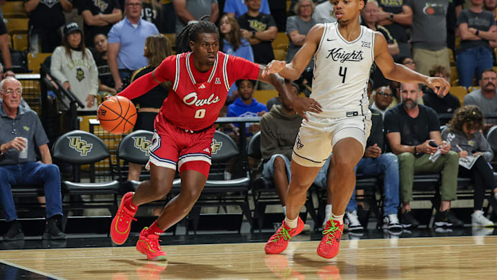 Nov 12, 2024; Orlando, Florida, USA; Florida Atlantic Owls guard Ken Evans Jr. (0) drives to the basket against UCF Knights guard Keyshawn Hall (4) during the first half at Addition Financial Arena. Mandatory Credit: Mike Watters-Imagn Images Nov 12, 2024; Orlando, Florida, USA; Florida Atlantic Owls guard Ken Evans Jr. (0) drives to the basket against UCF Knights guard Keyshawn Hall (4) during the first half at Addition Financial Arena. Mandatory Credit: Mike Watters-Imagn Images