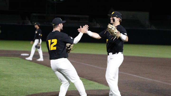 March 24, 2026; O’Fallon, Missouri; Missouri baseball’s Keegan Knutson (left, 12) high fives Jase Wiota (25, right) during a game against Illinois. March 24, 2026; O’Fallon, Missouri; Missouri baseball’s Keegan Knutson (left, 12) high fives Jase Wiota (25, right) during a game against Illinois.