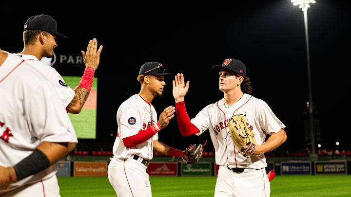 Roman Anthony high fives WooSox teammates following the Triple-A club's 12-2 win over Toledo on Tuesday at Polar Park.