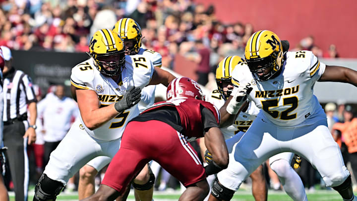 Oct 12, 2024; Amherst, Massachusetts, USA; Missouri Tigers offensive lineman Mitchell Walters (75) and offensive lineman Marcus Bryant (52)  blocking Massachusetts Minutemen defensive end Kofi Asare (94) during the first half at Warren McGuirk Alumni Stadium. Mandatory Credit: Eric Canha-Imagn Images