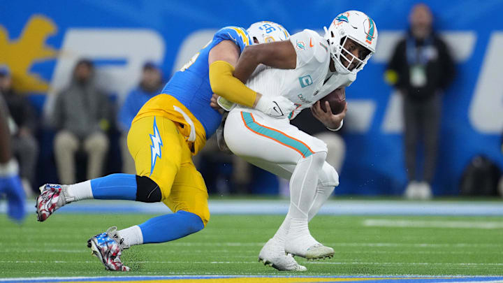 Dec 11, 2022; Inglewood, California, USA; Los Angeles Chargers defensive end Morgan Fox (56) sacks Miami Dolphins quarterback Tua Tagovailoa (1)