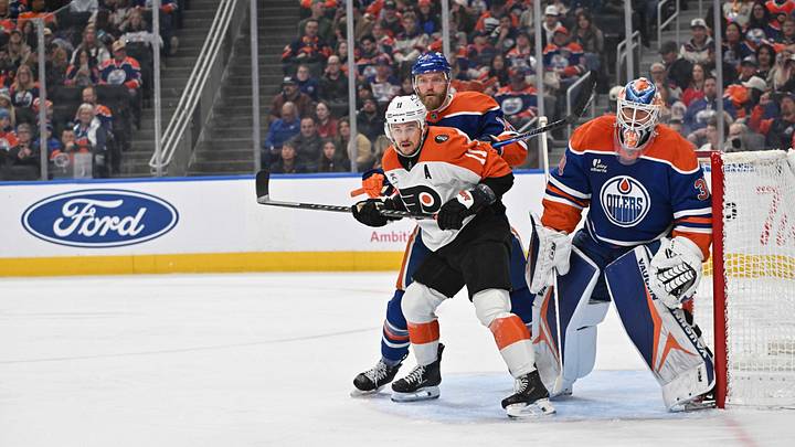 Jan 3, 2026; Edmonton, Alberta, CAN; Philadelphia Flyers right winger Travis Konecny (11) with Edmonton Oilers defenseman Mattias Ekholm (14) and Oilers goalie Calvin Pickard (30) are seen on the ice during the second period at Rogers Place. Mandatory Credit: Walter Tychnowicz-Imagn Images