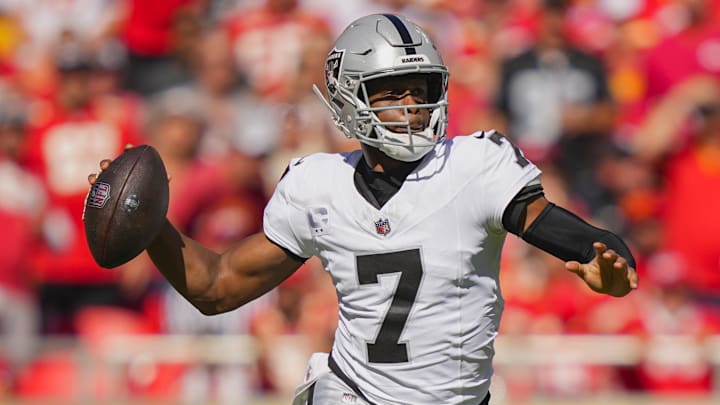 Oct 19, 2025; Kansas City, Missouri, USA; Las Vegas Raiders quarterback Geno Smith (7) rolls out to pass during the first half against the Kansas City Chiefs at GEHA Field at Arrowhead Stadium. Mandatory Credit: Jay Biggerstaff-Imagn Images