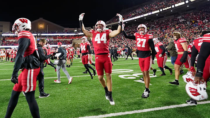 Nov 22, 2025; Madison, Wisconsin, USA; Wisconsin Badgers linebacker Cooper Catalano (44) and Wisconsin Badgers safety Raphael Dunn (27) react to winning 27-10 against the Illinois Fighting Illini at Camp Randall Stadium. Mandatory Credit: Kayla Wolf-Imagn Images