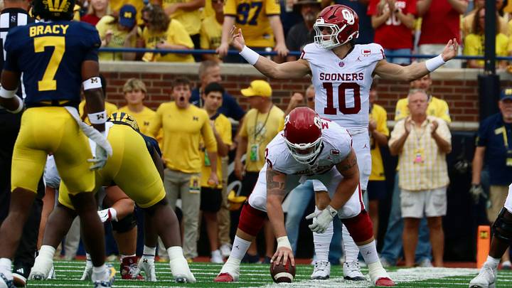 Oklahoma quarterback John Mateer scans the defense before a snap in the first half against the Michigan Wolverines. Oklahoma quarterback John Mateer scans the defense before a snap in the first half against the Michigan Wolverines.