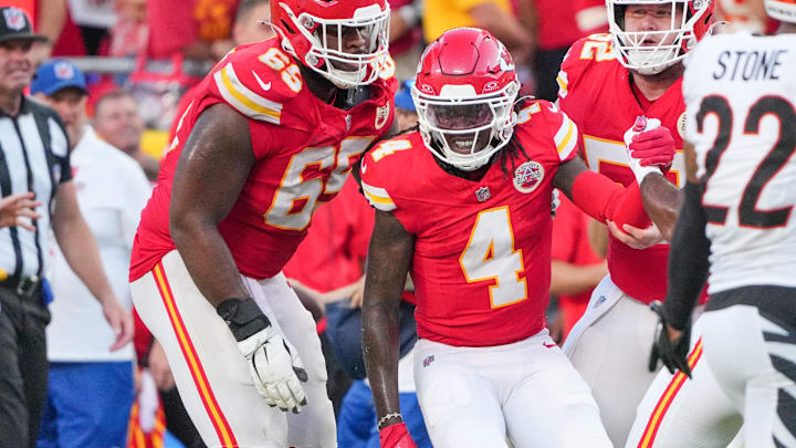 Sep 15, 2024; Kansas City, Missouri, USA; Kansas City Chiefs wide receiver Rashee Rice (4) is helped up by guard Trey Smith (65) against the Cincinnati Bengals after a penalty during the second half at GEHA Field at Arrowhead Stadium. Mandatory Credit: Denny Medley-Imagn Images