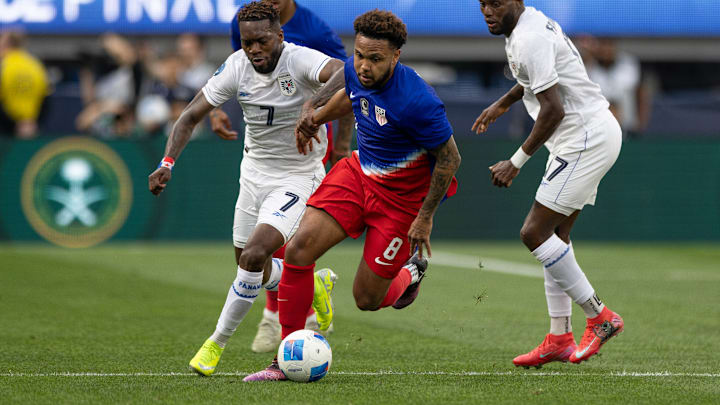 Weston McKennie dribbles away from defenders during the USMNT's Nations League semifinal game against Panama in March 2025.