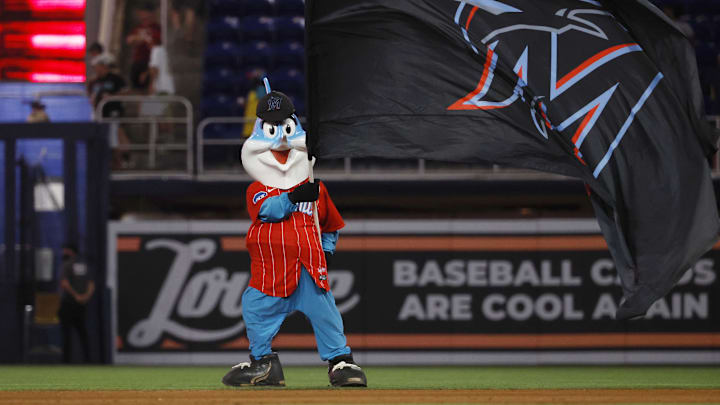 Jun 3, 2023; Miami, Florida, USA; Miami Marlins mascot Billy the Marlin waves a flag in the outfield against the Oakland Athletics following the game at loanDepot Park. Mandatory Credit: Rhona Wise-Imagn Images