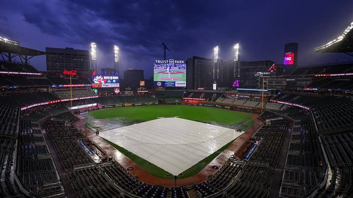 Jun 27, 2025; Atlanta, Georgia, USA; The tarp covers the field during a rain delay before a game between the Atlanta Braves and Philadelphia Phillies at Truist Park. Mandatory Credit: Brett Davis-Imagn Images