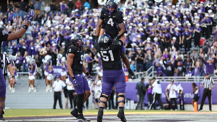 Nov 23, 2024; Fort Worth, Texas, USA; TCU Horned Frogs running back Cam Cook (4) celebrates with offensive lineman Coltin Deery (51) after scoring a touchdown against the Arizona Wildcats in the third quarter at Amon G. Carter Stadium. Mandatory Credit: Tim Heitman-Imagn Images