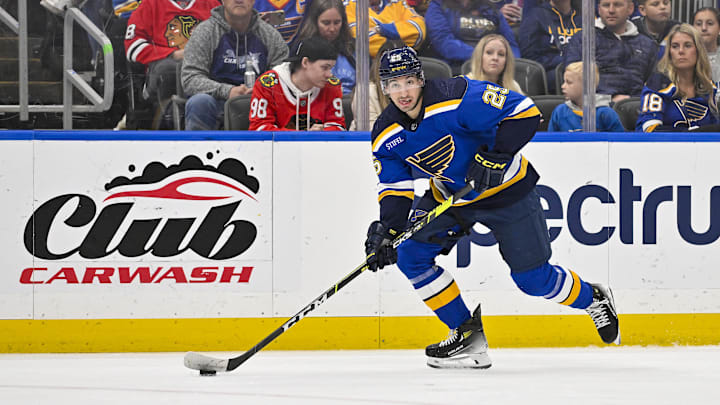 Apr 10, 2024; St. Louis, Missouri, USA;  St. Louis Blues center Jordan Kyrou (25) controls the puck against the Chicago Blackhawks during the second period at Enterprise Center. Mandatory Credit: Jeff Curry-Imagn Images