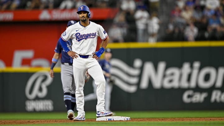 Jul 6, 2024; Arlington, Texas, USA; Texas Rangers second baseman Marcus Semien (2) advances to second base on a single against the Tampa Bay Rays by shortstop Corey Seager (5) during the third inning at Globe Life Field. Mandatory Credit: Jerome Miron-USA TODAY Sports