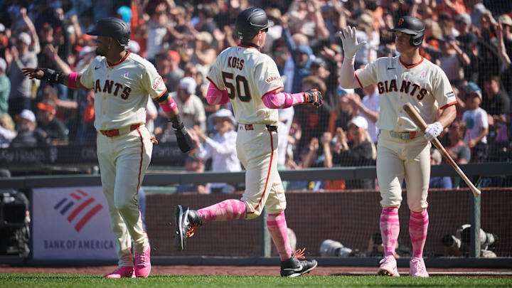 May 10, 2026; San Francisco, California, USA; San Francisco Giants infielder Christian Koss (50) celebrates with infielders Matt Chapman (26) and Luis Arraez (1) after scoring a run against the Pittsburgh Pirates during the tenth inning at Oracle Park. Mandatory Credit: Robert Edwards-Imagn Images