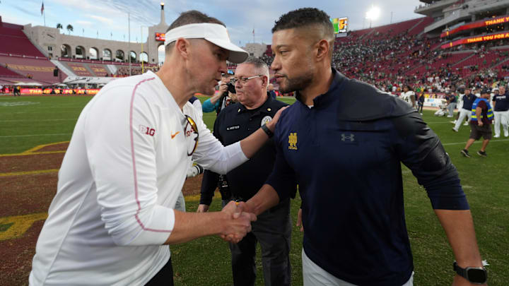 Nov 30, 2024; Los Angeles, California, USA; Southern California Trojans head coach Lincoln Riley and Notre Dame Fighting Irish head coach Marcus Freeman shake hands after the game at United Airlines Field at Los Angeles Memorial Coliseum. Mandatory Credit: Kirby Lee-Imagn Images