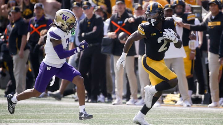 Iowa’s Kaleb Johnson (2) carries the ball downfield against Washington Saturday, Oct. 12, 2024 at Kinnick Stadium in Iowa City, Iowa.