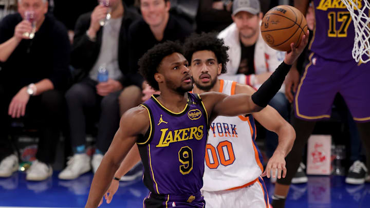 Feb 1, 2025; New York, New York, USA; Los Angeles Lakers guard Bronny James (9) drives to the basket against New York Knicks forward Jacob Toppin (00) and center Ariel Hukporti (55) during the fourth quarter at Madison Square Garden. Mandatory Credit: Brad Penner-Imagn Images Feb 1, 2025; New York, New York, USA; Los Angeles Lakers guard Bronny James (9) drives to the basket against New York Knicks forward Jacob Toppin (00) and center Ariel Hukporti (55) during the fourth quarter at Madison Square Garden. Mandatory Credit: Brad Penner-Imagn Images