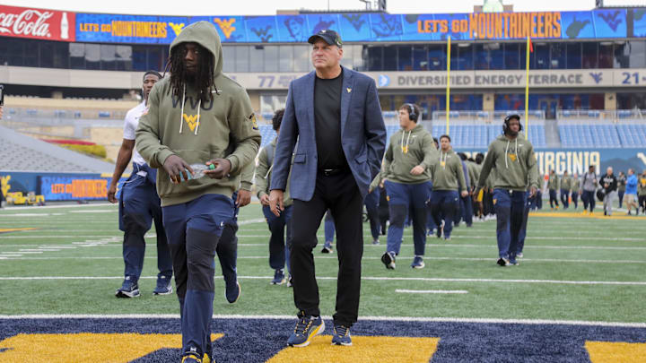 Nov 8, 2025; Morgantown, West Virginia, USA; West Virginia Mountaineers head coach Rich Rodriguez walks with his team as they arrive before their game against the Colorado Buffaloes at Milan Puskar Stadium. Mandatory Credit: Ben Queen-Imagn Images Nov 8, 2025; Morgantown, West Virginia, USA; West Virginia Mountaineers head coach Rich Rodriguez walks with his team as they arrive before their game against the Colorado Buffaloes at Milan Puskar Stadium. Mandatory Credit: Ben Queen-Imagn Images