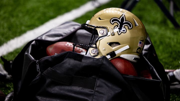 Nov 5, 2023; New Orleans, Louisiana, USA; Detailed view of the New Orleans Saints helmet and ball bag against the Chicago Bears during the first half at the Caesars Superdome. Mandatory Credit: Stephen Lew-Imagn Images Nov 5, 2023; New Orleans, Louisiana, USA; Detailed view of the New Orleans Saints helmet and ball bag against the Chicago Bears during the first half at the Caesars Superdome. Mandatory Credit: Stephen Lew-Imagn Images