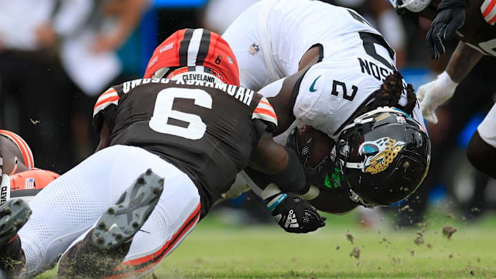 Jacksonville Jaguars running back D'Ernest Johnson (2) is tackled by Cleveland Browns linebacker Jeremiah Owusu-Koramoah (6) during the third quarter of an NFL football matchup Sunday, Sept. 15, 2024 at EverBank Stadium in Jacksonville, Fla. The Browns defeated the Jaguars 18-13. [Corey Perrine/Florida Times-Union]