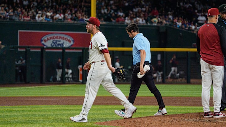 Jun 1, 2025; Phoenix, Arizona, USA; Arizona Diamondbacks starting pitcher Corbin Burnes (39) reacts after an injury in the fith inning and leaves the field against the Washington Nationals at Chase Field. Mandatory Credit: Allan Henry-Imagn Images