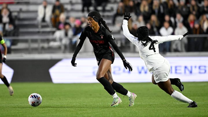 Dec 6, 2024; Cary, NC, USA; Stanford defender Lizzie Boamah (7) with the ball as Wake Forest midfielder Nikayla Small (4) defends in the first half at WakeMed Soccer Park. Mandatory Credit: Bob Donnan-Imagn Images
