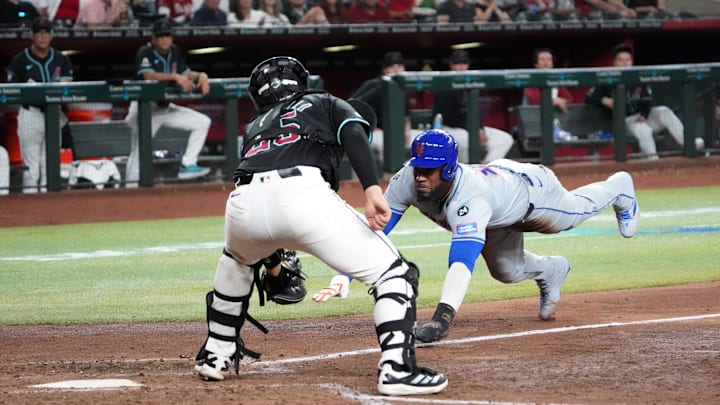 Aug 28, 2024; Phoenix, Arizona, USA; New York Mets outfielder Starling Marte (6) beats the tag of Arizona Diamondbacks catcher Adrian Del Castillo (25) to score a run during the sixth inning at Chase Field. Mandatory Credit: Joe Camporeale-Imagn Images