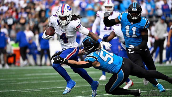 Oct 26, 2025; Charlotte, North Carolina, USA; Buffalo Bills running back James Cook III (4) runs against Carolina Panthers linebacker Christian Rozeboom (56). Oct 26, 2025; Charlotte, North Carolina, USA; Buffalo Bills running back James Cook III (4) runs against Carolina Panthers linebacker Christian Rozeboom (56).