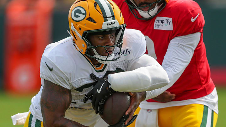 Green Bay Packers running back MarShawn Lloyd (32) takes a handoff in a drill during practice on Tuesday, August 12, 2025, at Ray Nitschke Field in Ashwaubenon, Wis.