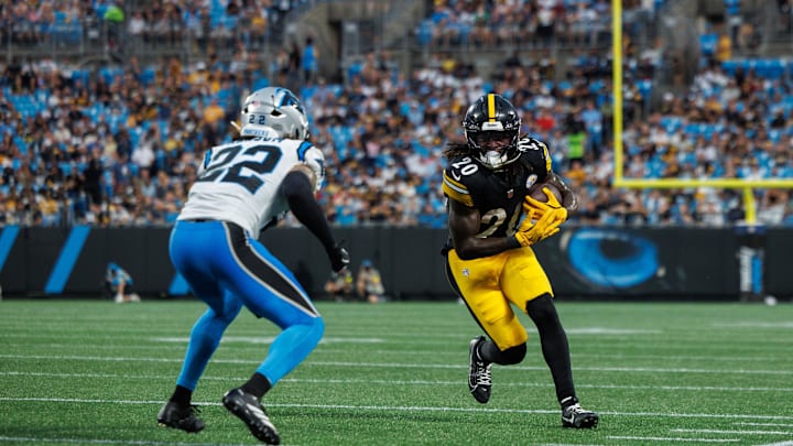  Aug 21, 2025; Charlotte, North Carolina, USA;  Pittsburgh Steelers running back Kaleb Johnson (20) runs the ball as Carolina Panthers safety Lathan Ransom (22) attempts to block him during the 2nd quarter at Bank of America Stadium. Mandatory Credit: Allison Lawhon-Imagn Images