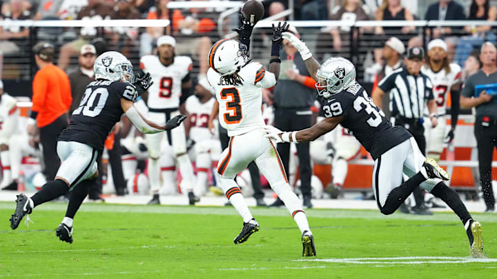 Sep 29, 2024; Paradise, Nevada, USA; Cleveland Browns wide receiver Jerry Jeudy (3) attempts a to make a catch between Las Vegas Raiders safety Isaiah Pola-Mao (20) and Las Vegas Raiders cornerback Nate Hobbs (39) during the fourth quarter at Allegiant Stadium. Mandatory Credit: Stephen R. Sylvanie-Imagn Images