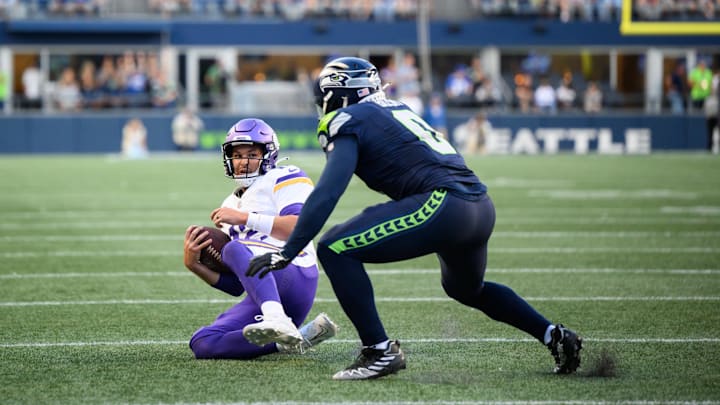 Minnesota Vikings QB Nick Mullens slides in front of Seattle Seahawks linebacker Devin Bush.