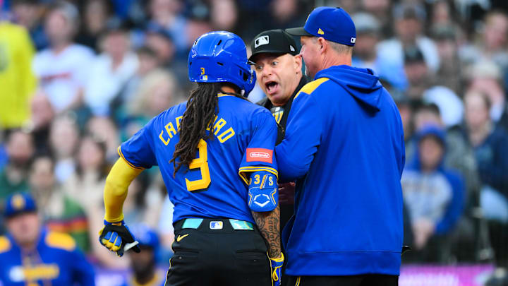 Seattle Mariners shortstop J.P. Crawford argues with home plate umpire Andy Fletcher (center) during a game against the Washington Nationals on May 29 at T-Mobile Park.