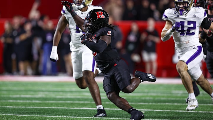 Sep 27, 2024; Piscataway, New Jersey, USA; Rutgers Scarlet Knights running back Kyle Monangai (5) carries the ball as Washington Huskies linebacker Carson Bruener (42) pursues during the first half at SHI Stadium.