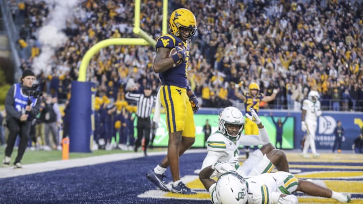 Nov 16, 2024; Morgantown, West Virginia, USA; West Virginia Mountaineers wide receiver Traylon Ray (7) catches a pass for a touchdown during the second quarter against the Baylor Bears at Mountaineer Field at Milan Puskar Stadium. Mandatory Credit: Ben Queen-Imagn Images