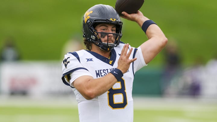 Sep 6, 2025; Athens, Ohio, USA; West Virginia Mountaineers quarterback Nicco Marchiol (8) warms up prior to their game against the Ohio Bobcats at Peden Stadium. Mandatory Credit: Ben Queen-Imagn Images