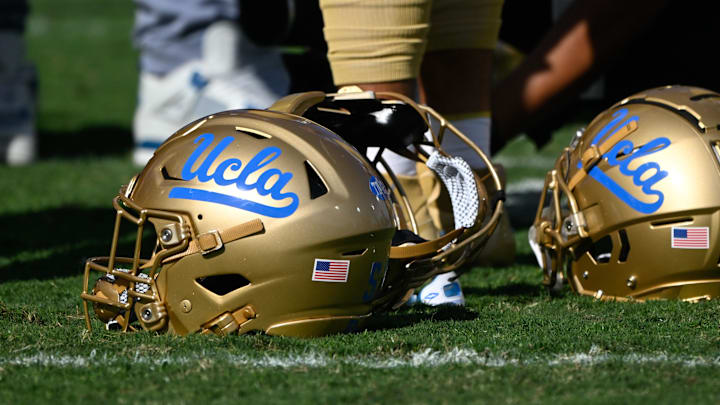 Nov 30, 2024; Pasadena, California, USA; UCLA Bruins helmets during pregame warmups before playing the Fresno State Bulldogs at Rose Bowl. Mandatory Credit: Robert Hanashiro-Imagn Images